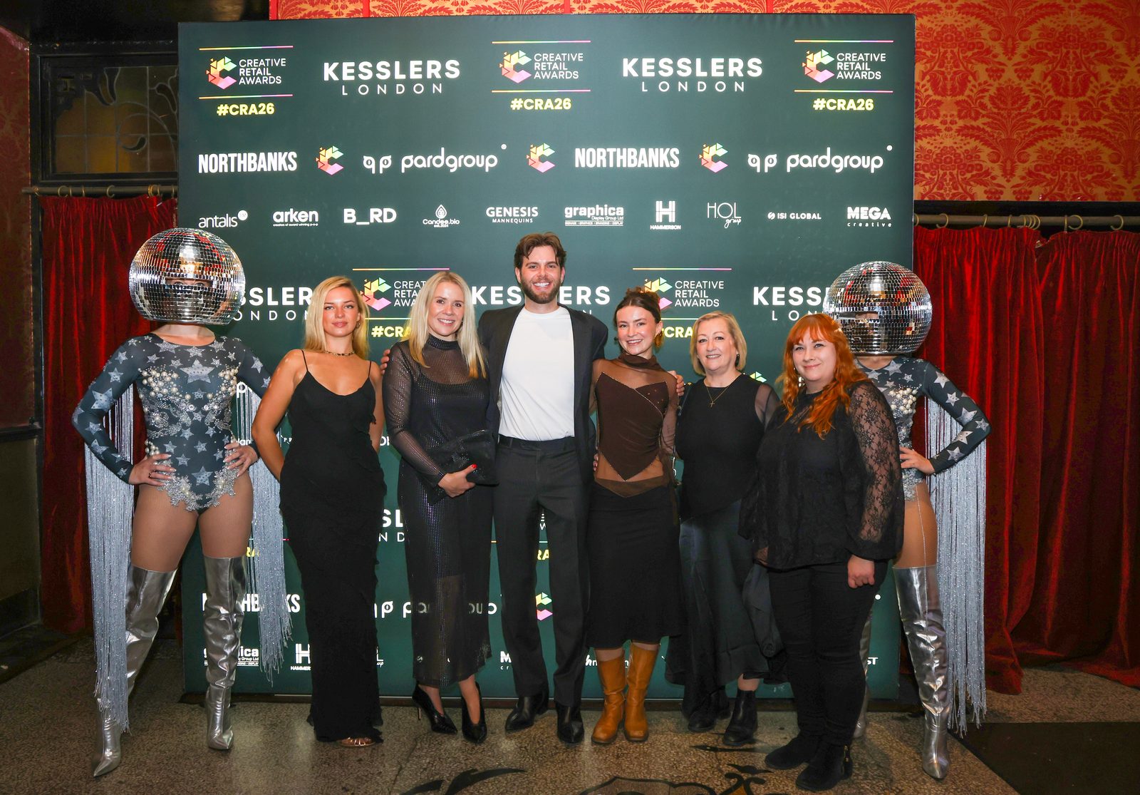 Guests and performers at the Kesslers London backdrop