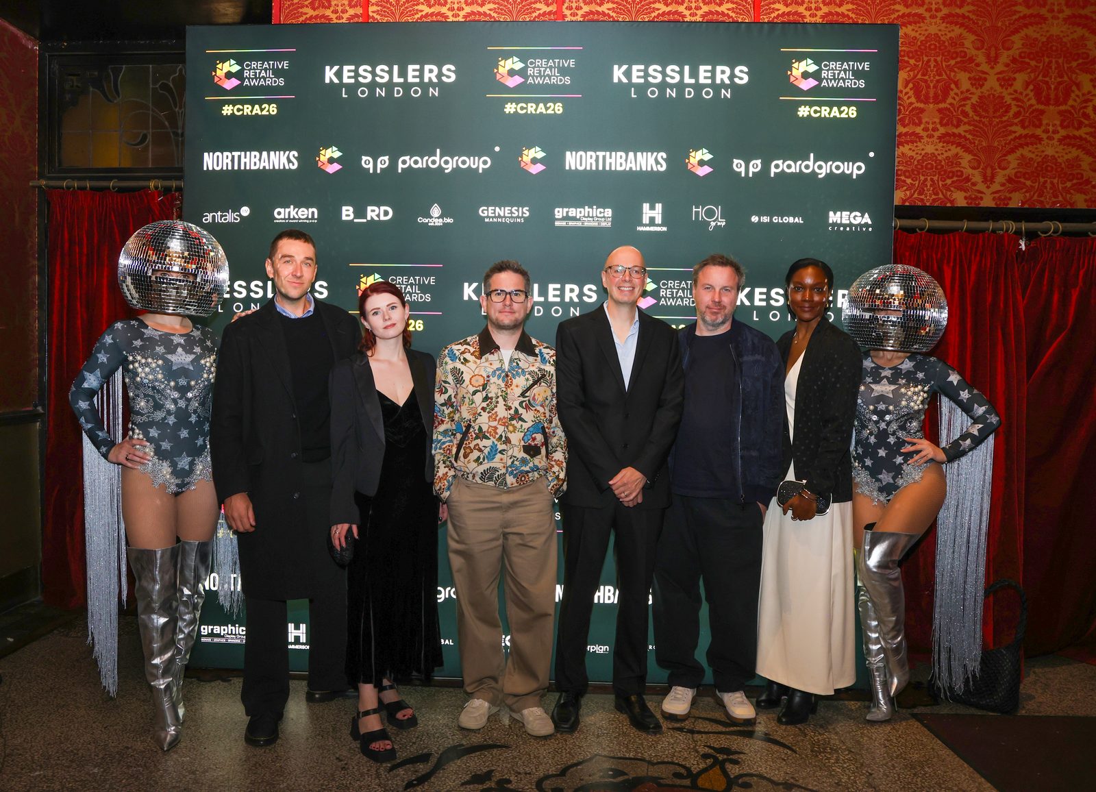 Guests with performers at the Kesslers London step and repeat